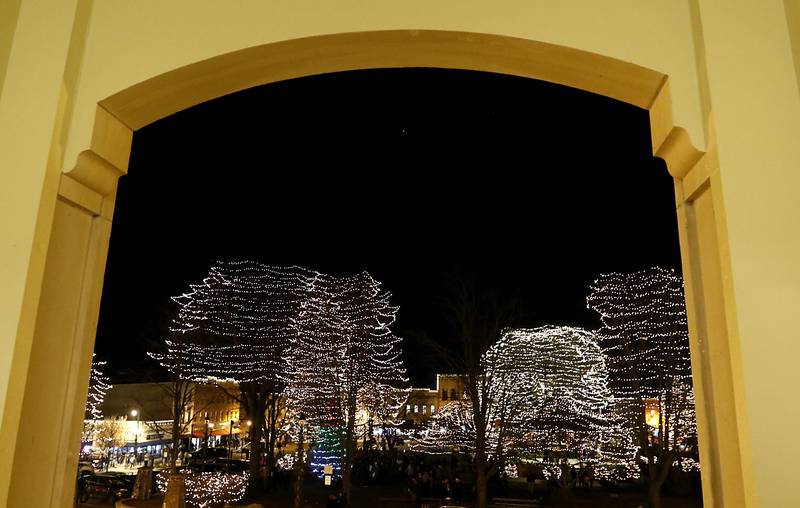The Lighting of the Square is framed by the entrance to the old courthouse on Friday, Nov. 29, 2024, in Woodstock. The annual holiday season event featured brass music, caroling, free doughnuts and cider, food trucks, festive selfie stations and shopping.