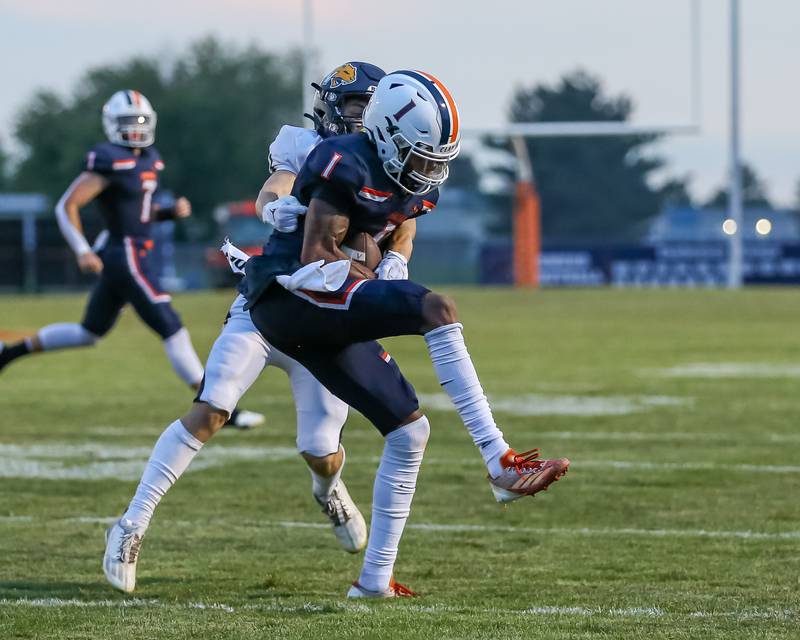 Oswego's Jeremiah Cain (1) comes down with a reception during a football game between Neuqua Valley and Oswego on Friday, Aug. 30, 2024 in Oswego. Gary E Duncan Sr for Shaw Local News Network.