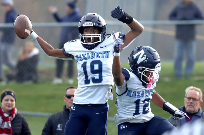 Nazareth’s Trenton Walker celebrates his touchdown with Edward McClain Jr., left, against Prairie Ridge in first-round Class 5A playoff football action at Crystal Lake Saturday.