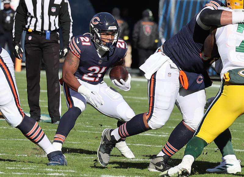Chicago Bears running back Darrynton Evans finds a hole in the Green Bat Packers defensive line during their game Sunday, Dec. 4, 2022, at Soldier Field in Chicago.