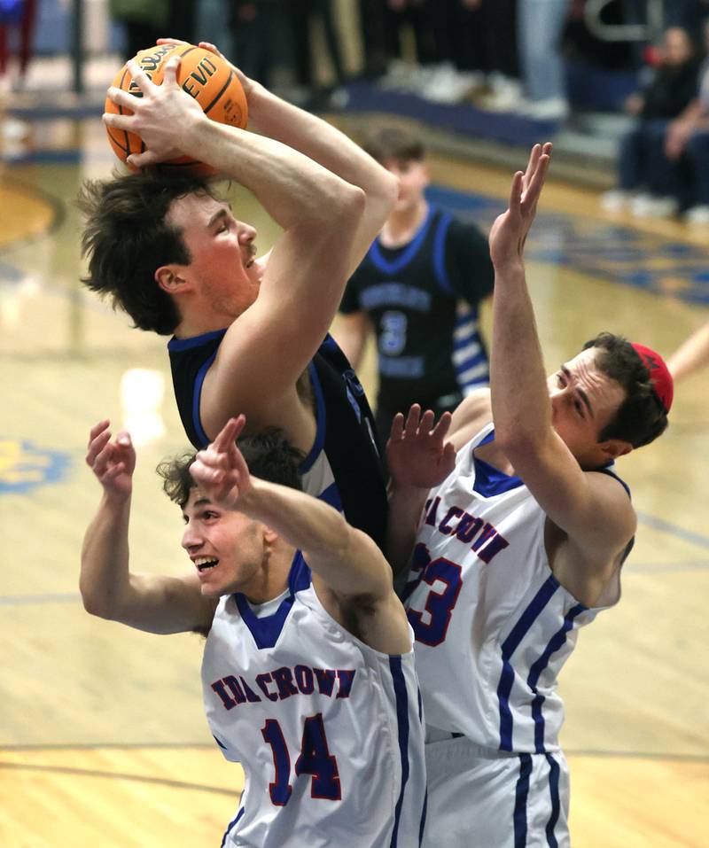 Hinckley-Big Rock's Martin Ledbetter grabs a rebound over Ida Crown’s Ezra Comrov (left) and Avi Okner during their Class 1A sectional game Wednesday, March 5, 2025, at Somonauk High School.