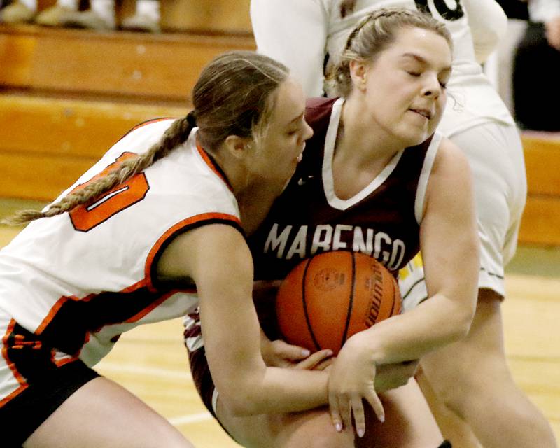 McHenry’s Avery Stinger and Marengo's Emilie Polizzi battle for possession of the basketball during the girl’s game of McHenry County Area All-Star Basketball Extravaganza on Sunday, April 13, 2025, at Alden-Hebron’s Tigard Gymnasium in Hebron.