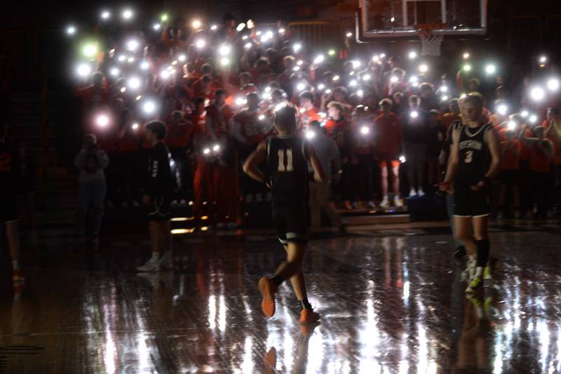 Byron's Cason Newton jogs out to meet Carson Buser as members of the Tigers' student section use the lights on their phones as the team is announced at the start of the 2A Supersectional in Sterling on Monday, March 4, 2024. The Tigers beat Chicago Latin 85-71 to advance to the state finals this week in Champaign. Byron will play Benton at 3:45 p.m. on Thursday in the semifinals. The 2A championship is scheduled for Saturday at 1 p.m.