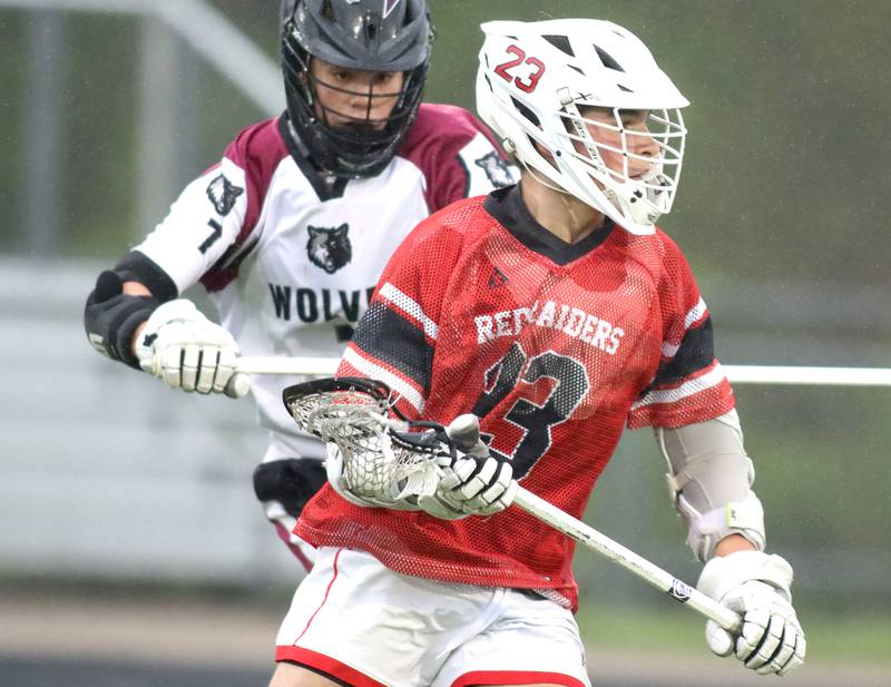 Huntley’s Dominic Scarpelli, front, gets past Prairie Ridge’s John Malina in varsity boys lacrosse at Prairie Ridge  High School in Crystal Lake on Thursday, May 1, 2025.