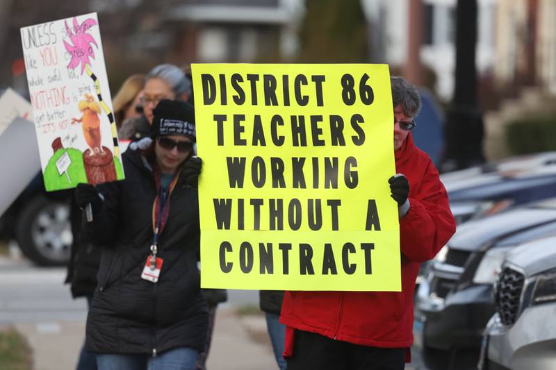 Teachers march outside District 86 Administrative Center on Monday in Joliet. District 86 teachers are currently working with a contract.