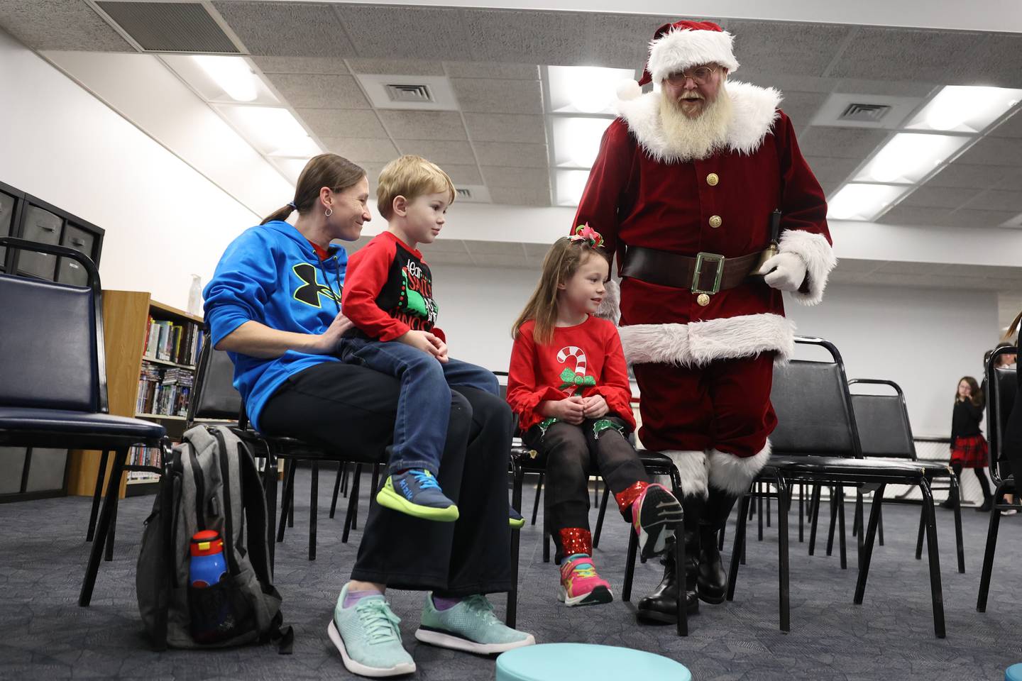 Santa greets Sarah Blackburn and her children Casey, 3, and Emily, 5, at the Shorewood-Troy Public Library.