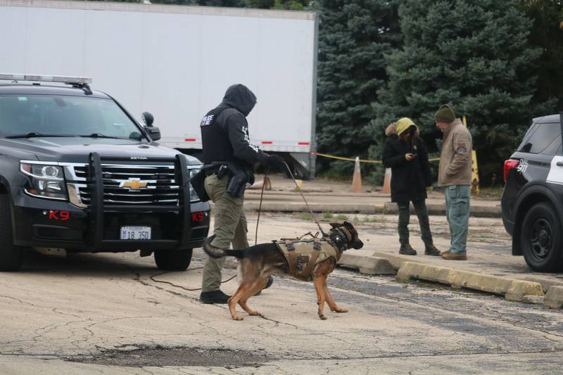 DeKalb police Sgt. Steve Parsons (left) is seen with Chase Oct. 22, 2025, preparing for a training sequence outside the former GE plant in DeKalb.