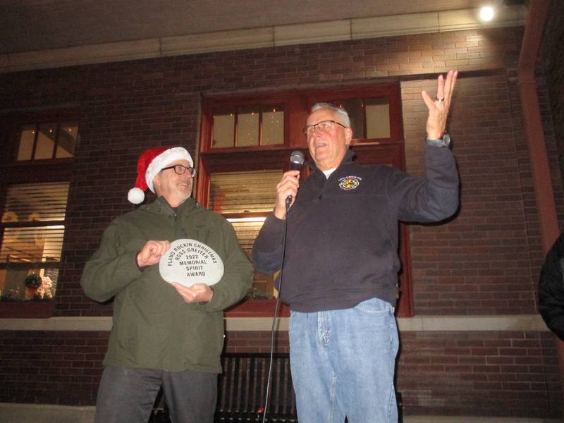 Little Rock-Fox Fire Protection Chief Greg Witek, right, accepts the Ross Greiter Spirit Award from Plano Mayor Mike Rennels at the end of the annual Plano Rockin' Christmas Parade on Dec. 2, 2022.