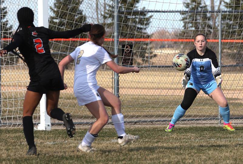 Sycamore's keeper Brooke Cutlip saves a shot off of the foot of Plainfield East's Kessiah Purnell during their game Tuesday, March 25, 2025, in the Barb Fest tournament at DeKalb High School.