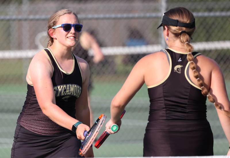 Sycamore’s Lizzie McConkie (left) congratulates teammate Maggie Klein after a point during their doubles match against DeKalb Wednesday, Sept. 18, 2024, at Sycamore High School.