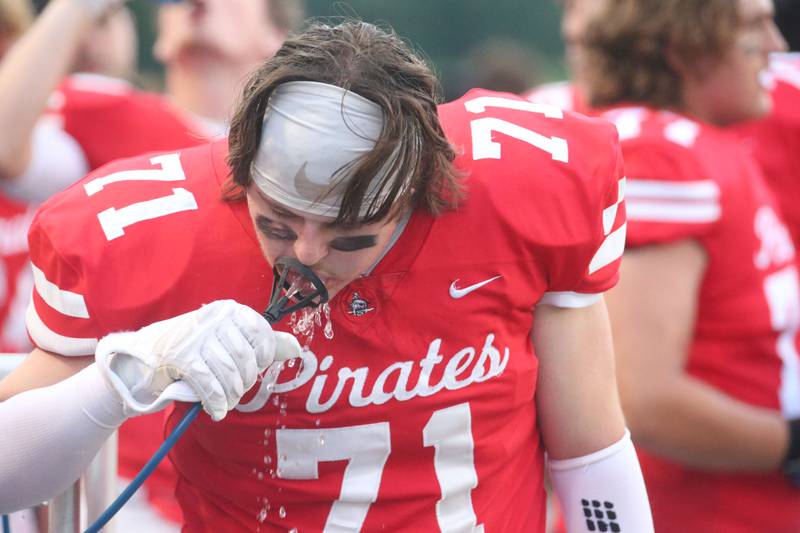 Ottawa's Jaxon Carrier takes a drink of water before playing Plano on Friday, Aug. 30, 2024 at King Field.