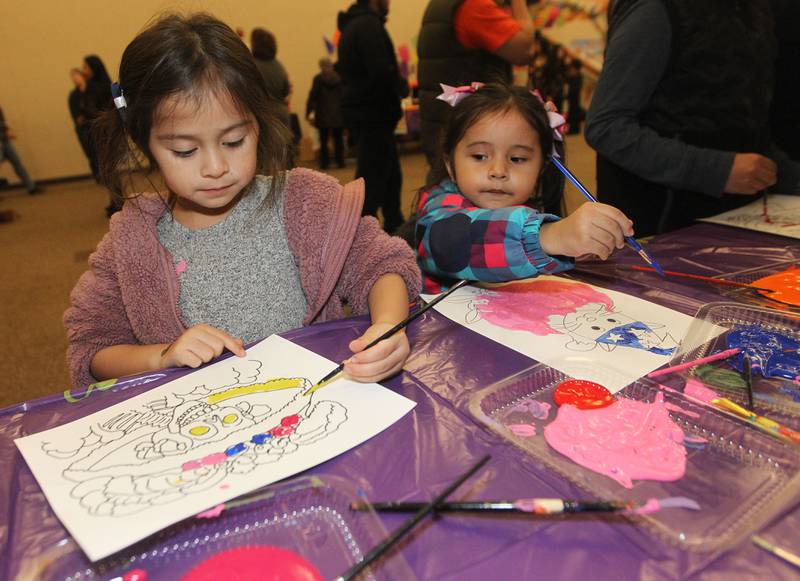 Luna Cuevas, of Grayslake paints a La Calavera Catrina picture as she stands next to Kimberly Franco, of Round Lake, both 5, during the Day of the Dead Celebration at the Round Lake Beach Cultural & Civic Center.
