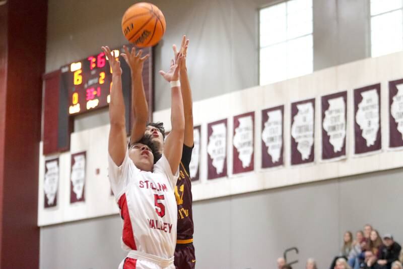 Richmond-Burton’s Prestyn Misch and Stillman Valley’s Donell Foreman reach for the ball during 74th Annual E.C. Nichols Holiday Classic varsity boys basketball tournament action on Saturday, Dec. 28, 2024 at Marengo High School in Marengo.