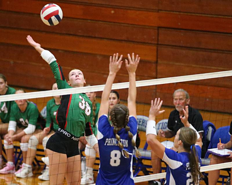 L-P's Aubrey Duttlinger spikes the ball past Princeton's Keighley Davis and teammate Ellie Harp on Tuesday, Aug. 27, 2024 at Princeton High School.