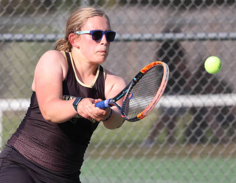 Sycamore’s Lizzie McConkie hits a backhand during her doubles match against DeKalb Wednesday, Sept. 18, 2024, at Sycamore High School.