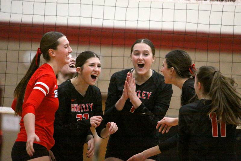 Huntley’s Red Raiders celebrate a two-set win over Burlington Central in varsity volleyball at Huntley High School in Huntley on Thursday, Oct. 24, 2024.