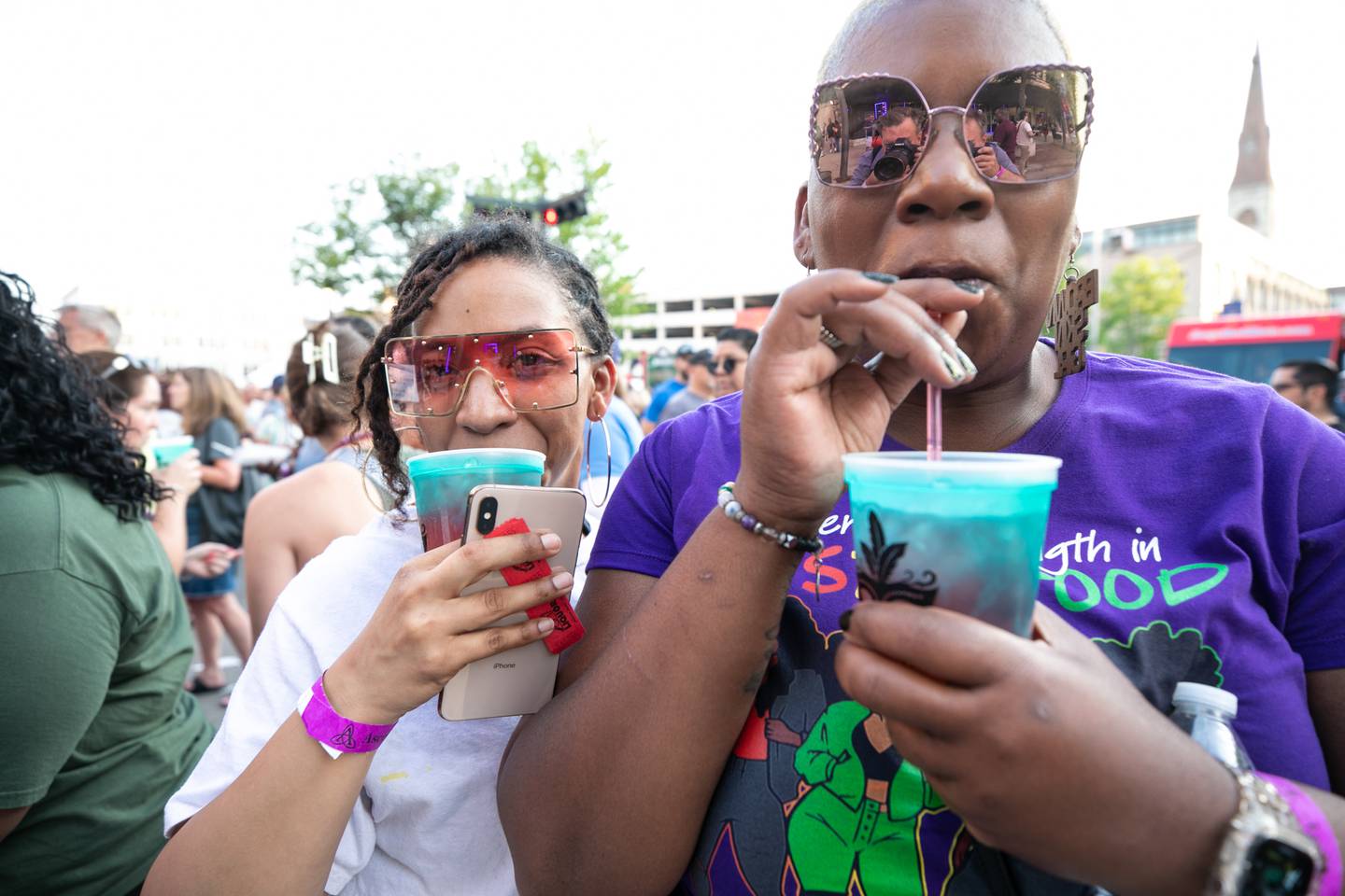 Kailyn Brad, left and Tamesha Thompson sip on colorful beverages at the New Orleans North Festival, on Friday, June 2, 2023.