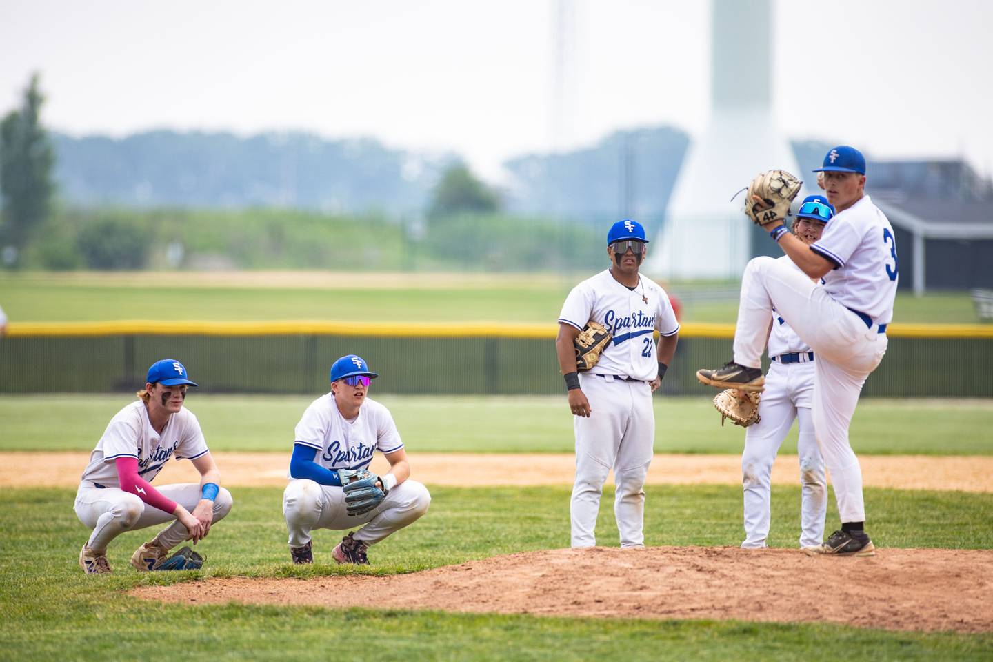 St Francis’ infield watches pitcher Peter Solloway warm up after he was brought into the game against Benet Academy during the Class 3A Kaneland Sectional final at Kaneland High School in Maple Park on Saturday, June 7, 2025.