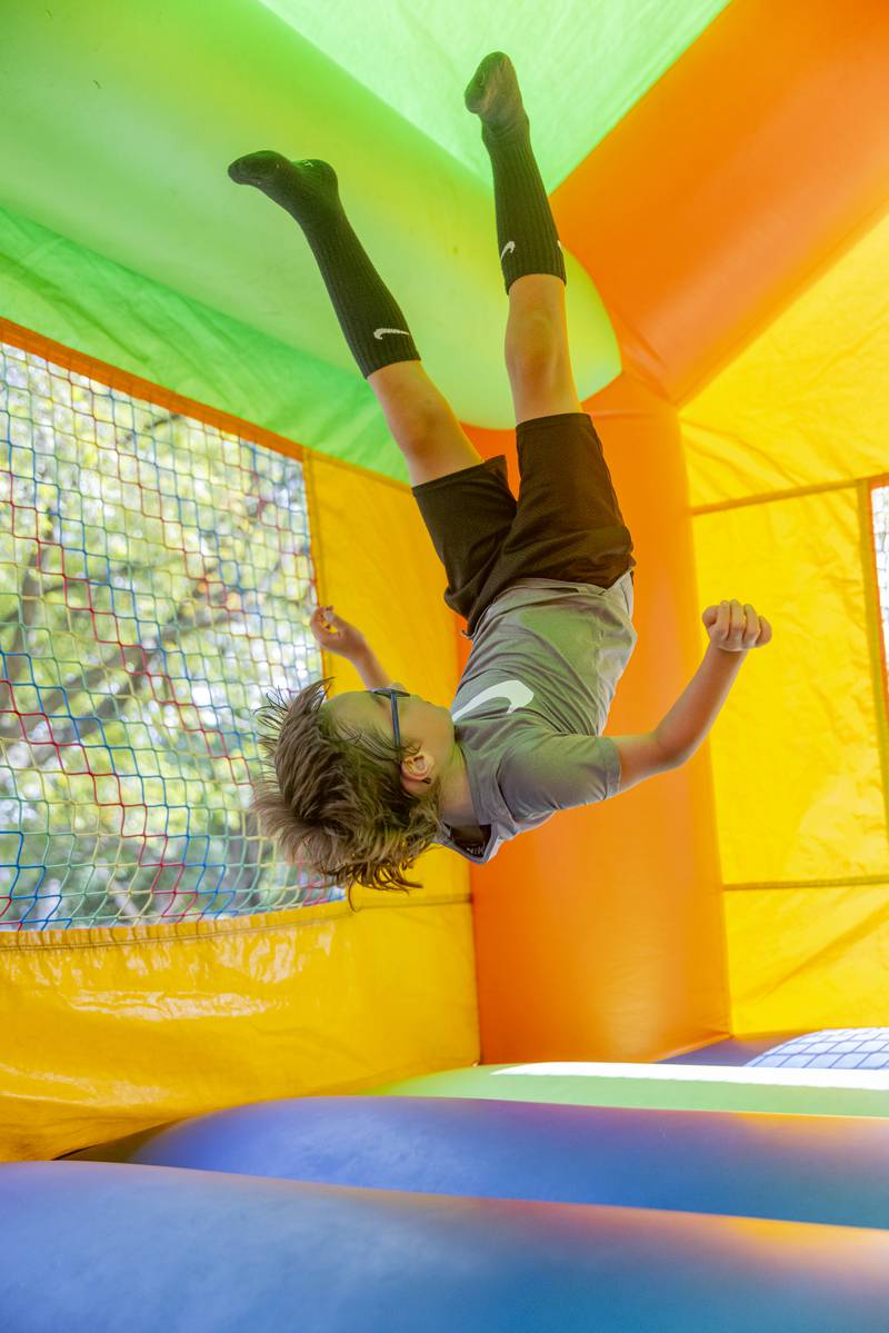Leo Dipietro performs a front flip in one of the bounce houses Saturday, June 15, 2024, during Beef and Ag Days at Soldiers and Sailors Park in Princeton.