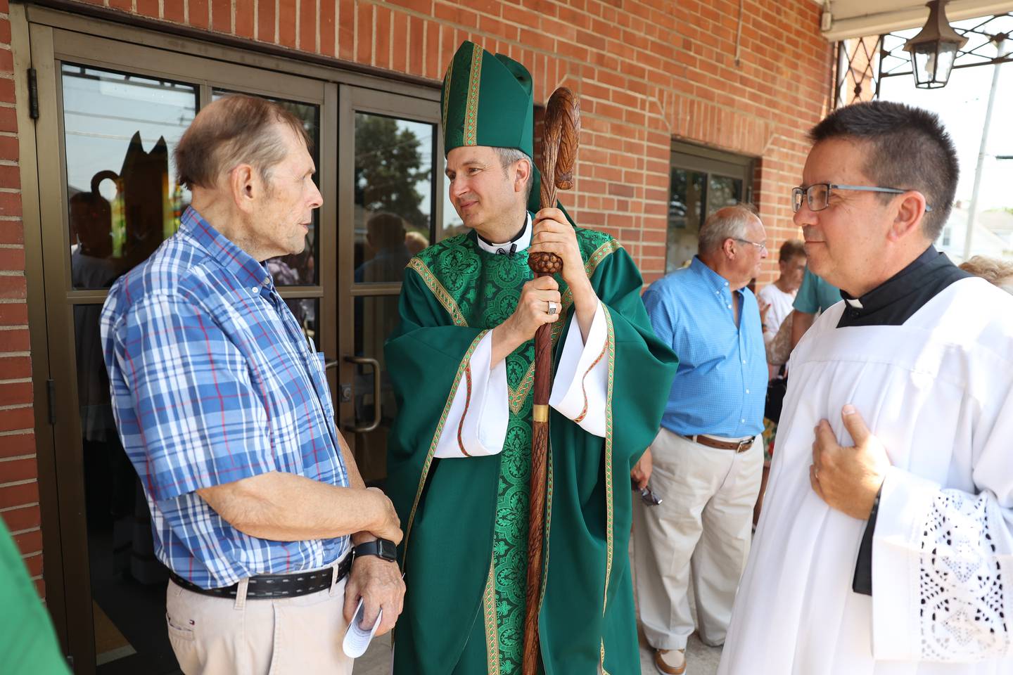 Bishop Ronald Hicks, center, speaks to a parish member after Saint Anne’s final mass on June 16, 2024 in Crest Hill.