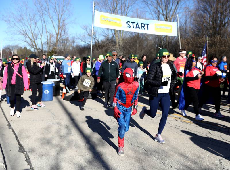 A young runner dressed as Spiderman takes off at the start of the Wheaton Park District’s Superhero 3K Fun Run at the Sensory Garden Playground in Lisle on Saturday, April 6, 2024.