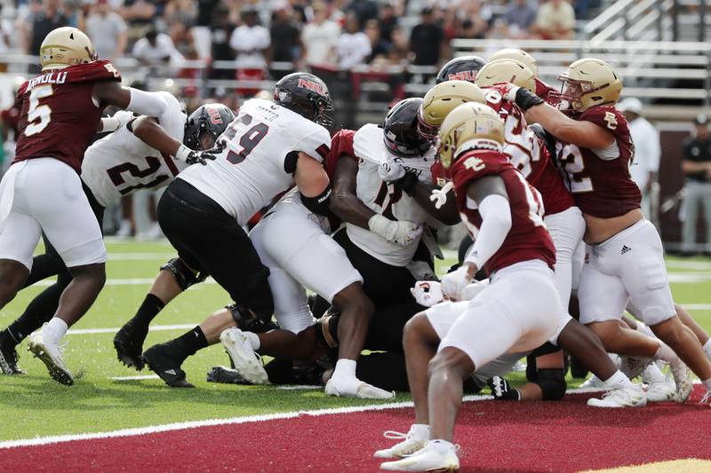Northern Illinois quarterback Rocky Lombardi (12), center, carries into the end zone during overtime in an NCAA college football game against Boston College, Saturday, Sep. 2, 2023, in Boston. (AP Photo/Michael Dwyer)