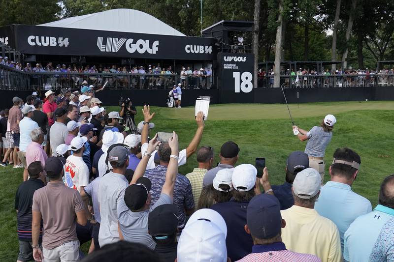 Spectators watch Cameron Smith chip onto the 18th green during the first round of the LIV Golf Invitational-Chicago tournament Friday in Sugar Grove. Local businesses hope for "residual spending" in Sugar Grove and surrounding communities associated with spectators and participants.