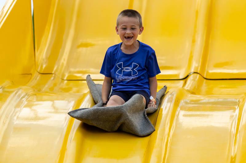 Plainfield resident Mark Plop enjoys the giant slide at Plainfield Fest, presented by the Plainfield Riverfront Foundation, on June 29, 2025.