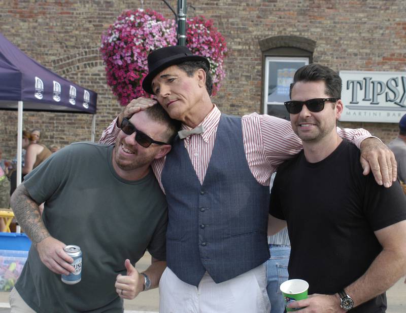 Jake Wessel and Dillon Grandon pose with Street Entertainer Michael Lee at Dixon's Venetian Night. Venetian Night featured magicians, street performers, face painting, a spaghetti eating contest, mini boat races, a drone light show and more. The Discover Dixon event was held along the riverfront in Dixon on Aug. 9, 2025.