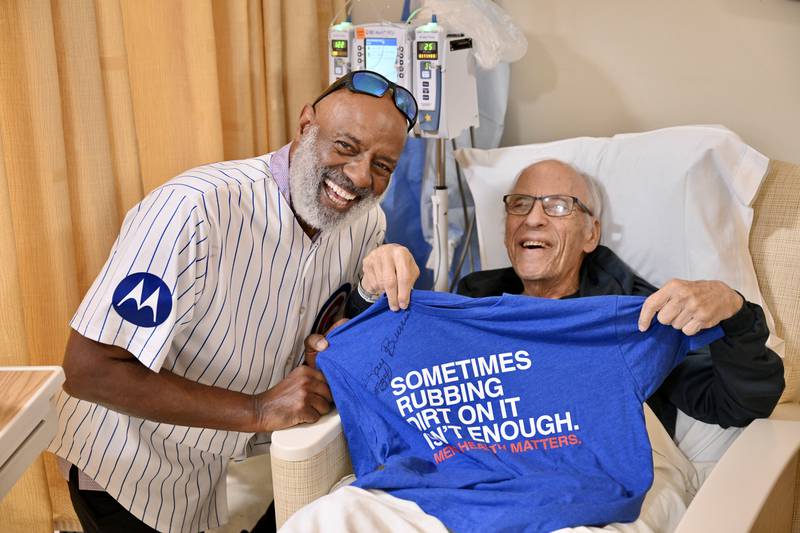 Chicago Cubs alum Ray Burris shares a laugh June 12 with patient Bernie at the infusion center at Advocate Condell Medical Center in Libertyville.