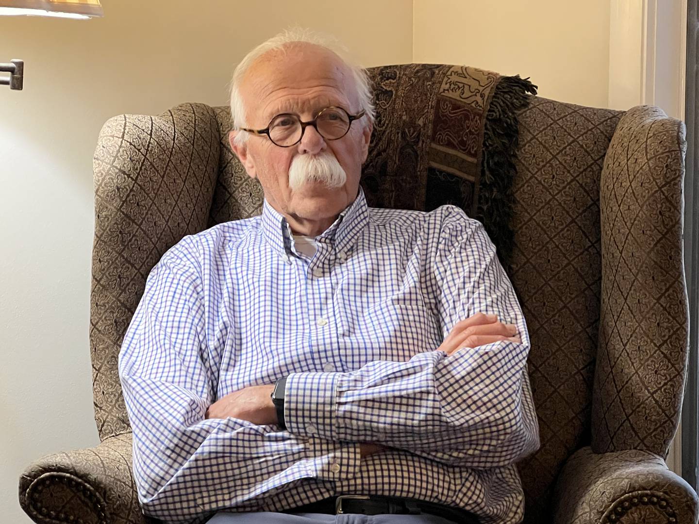 Larry Berke sits in his living room in a city of DeKalb apartment.