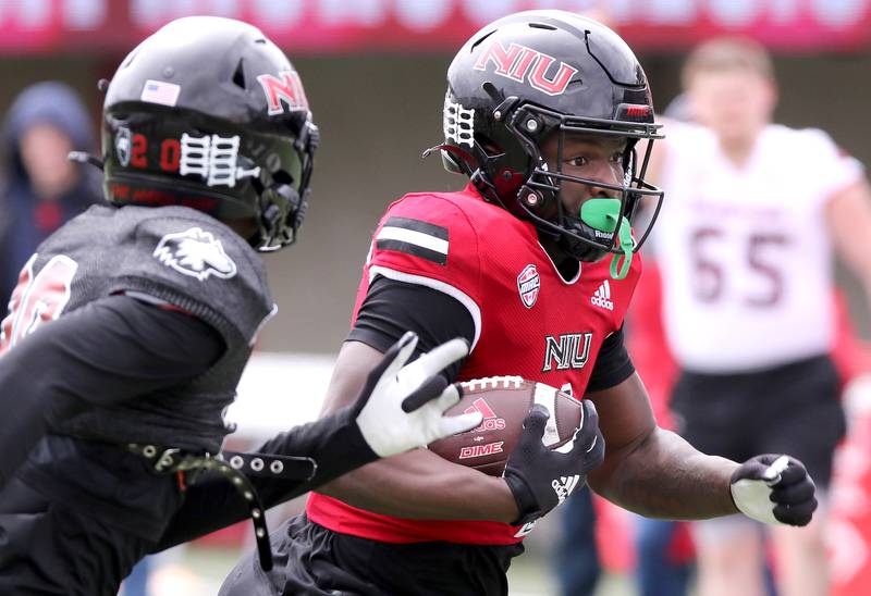 Northern Illinois running back Antario Brown is pursued by cornerback Jacob Finley during the NIU football Spring Showcase Saturday, April 22, 2023, at Huskie Stadium at NIU in DeKalb.