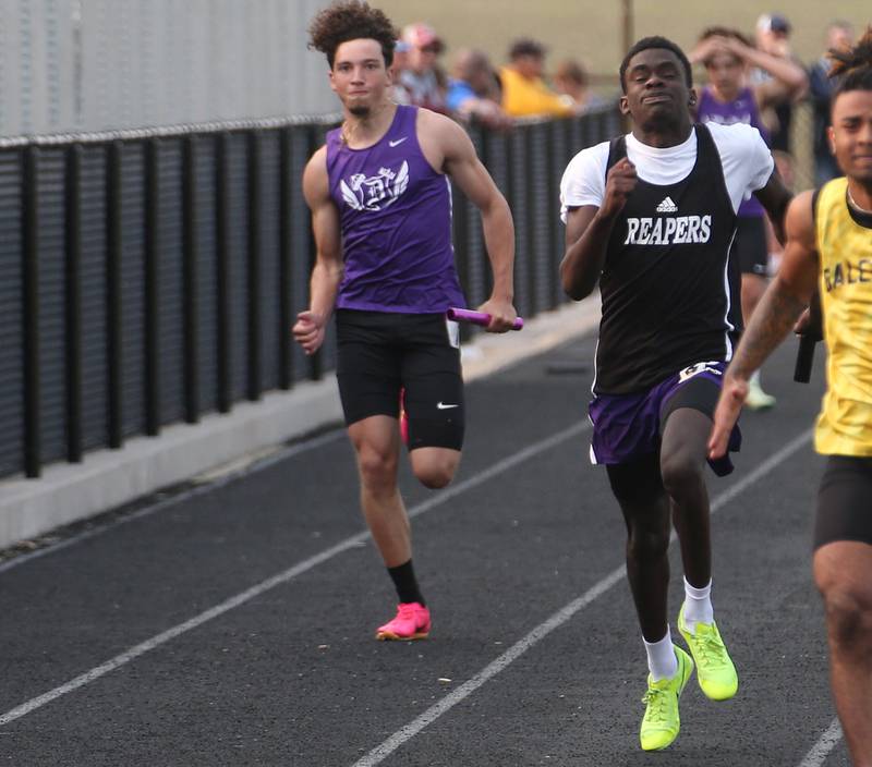 Dixon's Tyson Dambman and Plano's Damani Carter compete in the 4x100 meter relay during the Class 2A track sectional meet on Wednesday, May 17, 2023 at Geneseo High School.