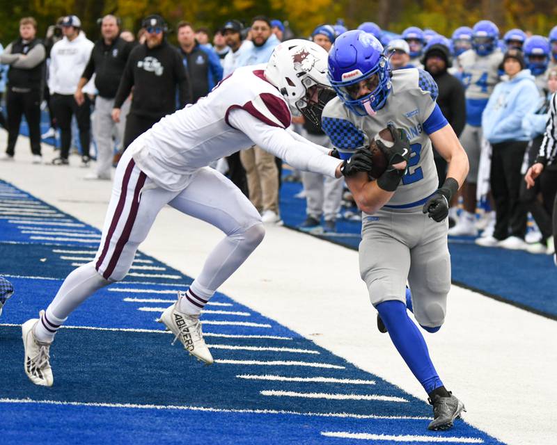 St. Francis's Dario Milivojevic (12) gains some yards before being pushed out of bounds by Prairie Ridge's Eligah Loeding (3) during the second round of the 5A playoff game on Saturday Nov. 8, 2025, held at St. Francis's High School.