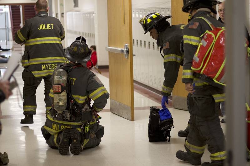 Firefighters inside Joliet West High School on Tuesday, March 25, 2025, for a staged emergency drill simulating the aftermath of a gas explosion.