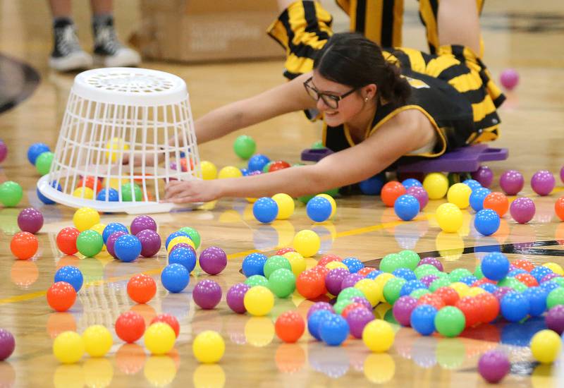 Putnam County High School student Addy Leatherman collects balls in her basket while playing a game during the football Homecoming Pep Rally on Friday, Sept. 27, 2024 at Putnam County High School in Granville.