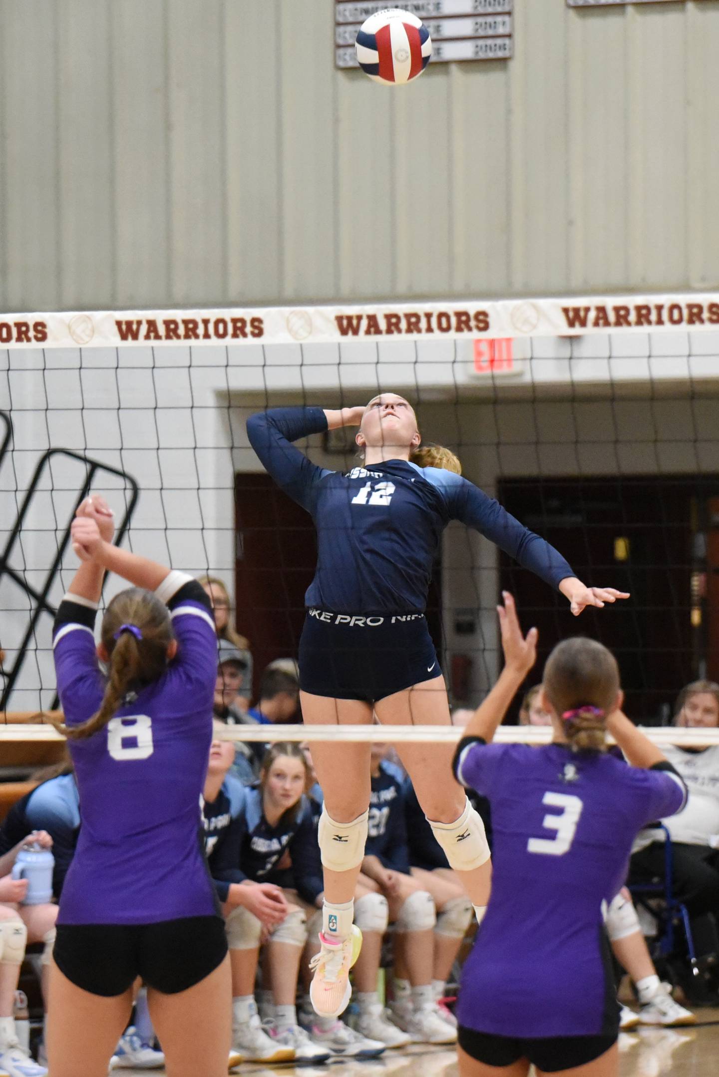 Cissna Park's Josie Neukomm, center, times her hit as Lexington's Avery Poppe, left, and Jaclyn Grunloh prepare to defend during the IHSA Class 1A Watseka Sectional championship Thursday, Nov. 6, 2025.
