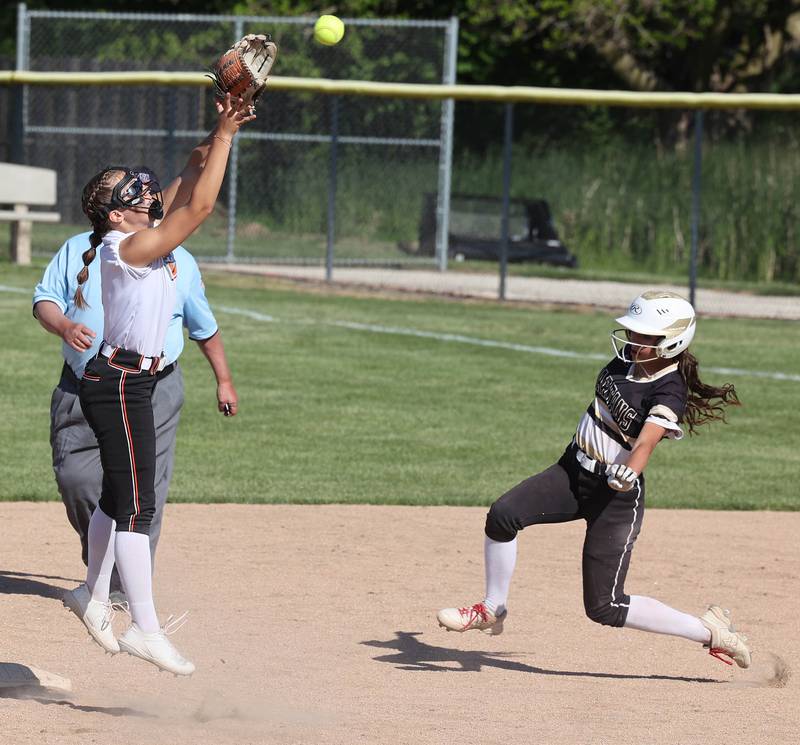 Sycamore's Bella Jacobs slides in with a stolen base as Freeport's Kailen Pro catches the high throw during their Class 3A regional championship game Friday, May 26, 2023, at Sycamore High School.