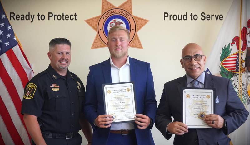 Kendall County Undersheriff Bobby Richardson, left, stands next to the Sheriff's Office two new correctional deputies, Austin West, middle and Adan Vasquez, right.