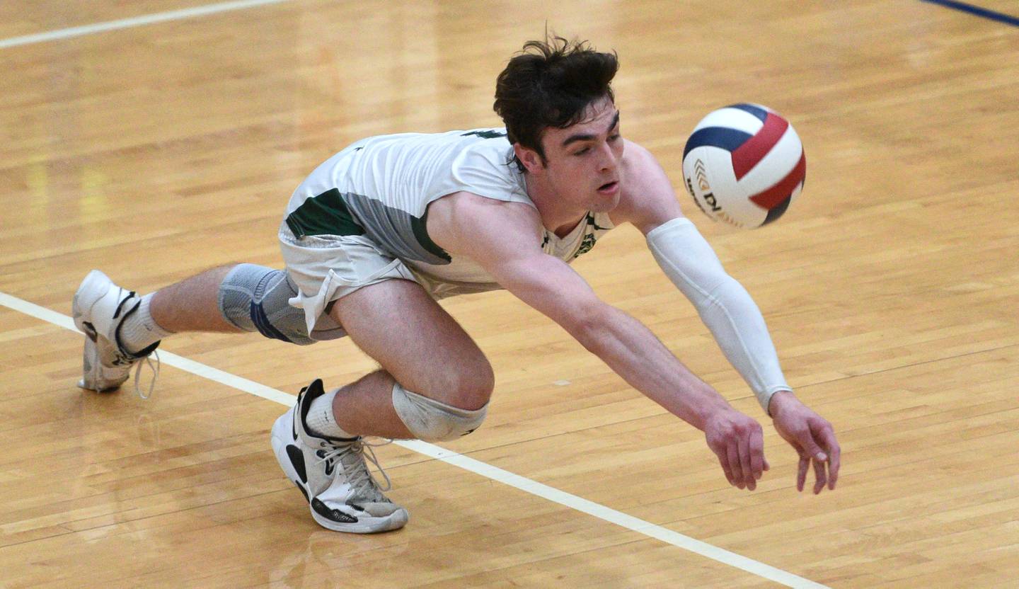 Glenbard West's Casey Maas dives and connects with the ball to keep the play alive against Lyons Township in  Saturday’s state boys volleyball championship  match in Hoffman Estates.