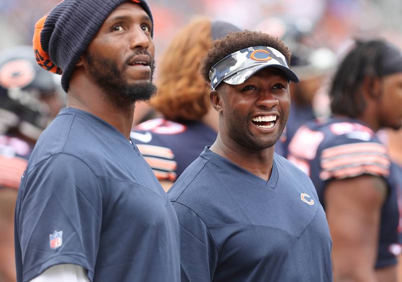 Chicago Bears defensive end Robert Quinn (left) and linebacker Roquan Smith talk on the sidelines during their preseason game against Kansas City Sunday, Aug. 13, 2022, at Soldier Field in Chicago.