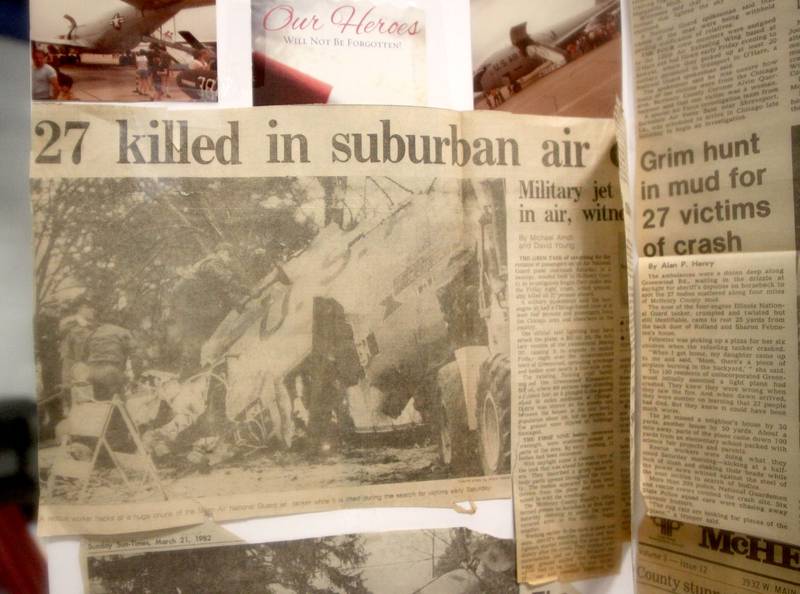 News clippings are displayed as a remembrance was held Saturday at Wonder Lake Fire Protection District Station 2 on the 40th anniversary of a midair military jet explosion that happened over the small, rural area northeast of Woodstock. The plane exploded midair at 9:11 p.m. on March 19, 1982, its flaming pieces raining over a 2-mile area near Greenwood. On board were more than two-dozen members of the Air Force Reserve and Air National Guard. Twenty-seven people died.