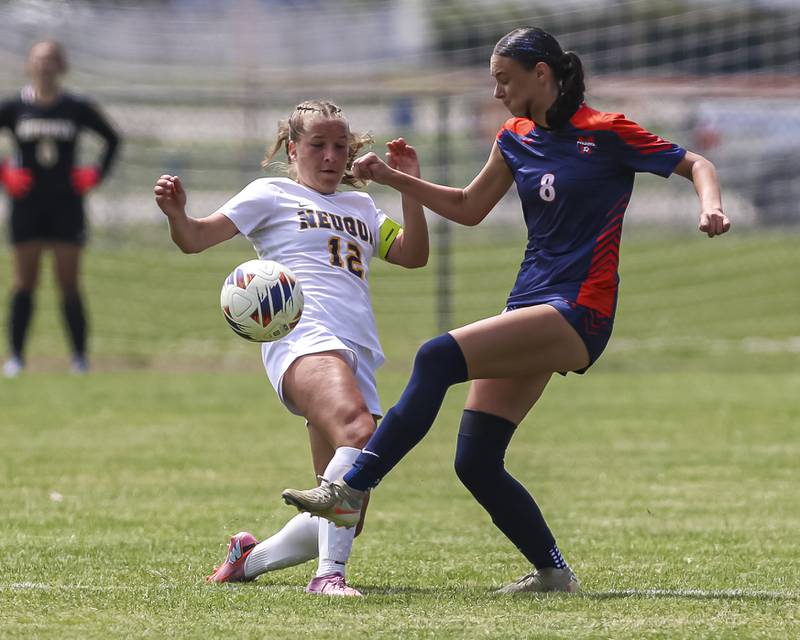 Oswego's Gianna Rizzo (8) and Neuqua Valley's Addison Guskey (12) converge on the ball during Class 3A regional final soccer match between Neuqua Valley at Oswego on Saturday, May 23, 2026 in Oswego.