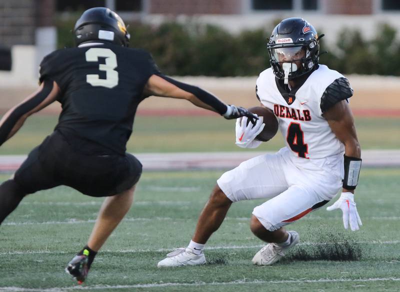 DeKalb's Xavier Dandridge puts a move on Sycamore's Carter York during the First National Challenge game Friday, Aug. 25, 2023, in Huskie Stadium at Northern Illinois University in DeKalb.