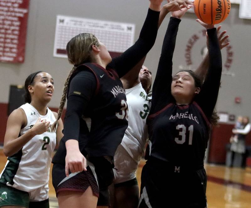 Marengo’s Ariana Rodriguez, right, and Macy Noe, front, battle for a rebound with St. Edwards’ Savannah Lynch, left, and Jordin Sauls in IHSA Regional Championship girls basketball on Thursday, Feb. 19, 2026, at Marengo High School in Marengo.