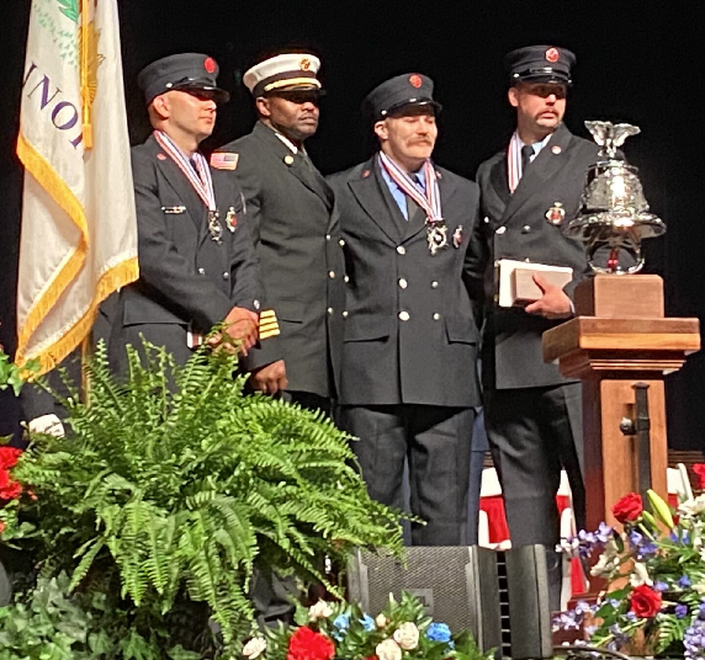 Medal of Valor honorees Sterling Fire Department Lt. Adrian Avelar (left), and firefighters Jeff Kimpel and Lucas Pfister, second from right and far right, with Urbana Fire Department Chief Demond Dade, a member of the Firefighting Medal of Honor Committee who presented their awards Tuesday, May 10, 2022, at the 29th annual Fallen Firefighter Memorial and Medal of Honor Ceremony in Springfield.