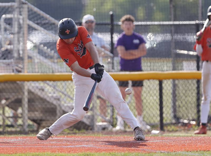 St. Charles East's Mac Paul (14) makes contact during the Class 4A York regional semi-final between Wheaton Warrenville South and St. Charles East in Elmhurst on Thursday, May 23, 2024.