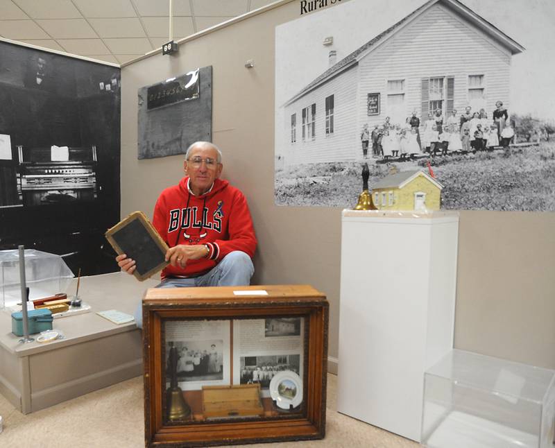 Bob Frenz, who is a retired educator from Huntley, is photographed with the McHenry County Historical Society and Museum’s exhibit about one-room schools. He has written about the history of schools in McHenry County and specializes in how one-room schoolhouses consolidated and modernized in the ‘40s and ‘50s.