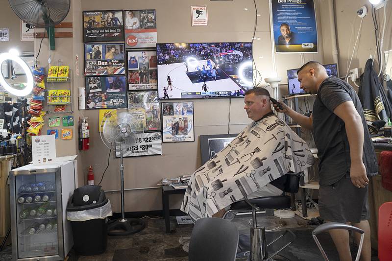 Brian Lee of Dixon gets a hair cut by Jose Herrera on Tuesday, July 30, 2024, at Ben’s Phresh Kutz in Rock Falls. Lee and son Colton, 7, both took the day to freshen up.
