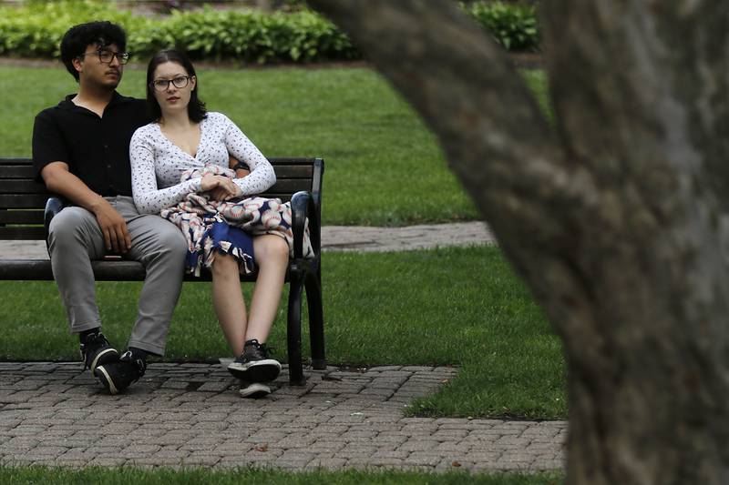 Alfredo Cabrera and Emma Barrett listen to the music of the Woodstock City Band as they perform on Wednesday, July 24, 2024, in the historic Woodstock Square. The band that is in its 140th season, performed their Galloping through the Gallery concert for the crowd.